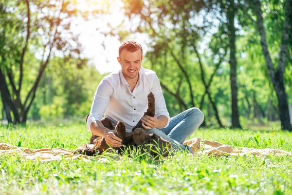 Jongeman met een hond in het park — Stockfoto