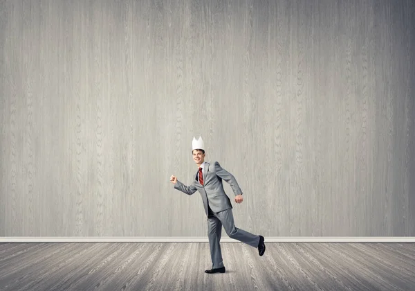 King businessman in elegant suit running in empty room — Stock Photo, Image