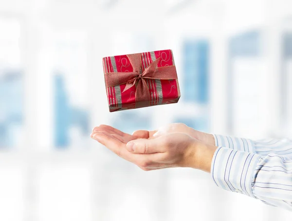 Concept of xmas or celebration with present box in male palms. Mixed media — Stock Photo, Image