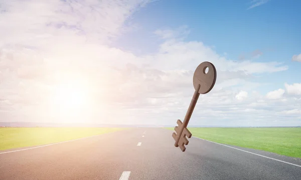 Conceptual background image of concrete key sign on asphalt road — Stock Photo, Image