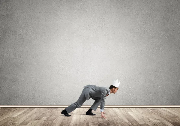 King businessman in elegant suit running in empty room — Stock Photo, Image