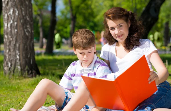 Boy and woman reading book — Stock Photo, Image