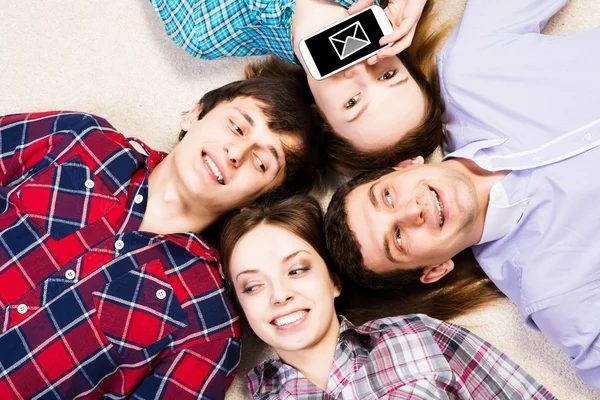 stock image four young men lie together