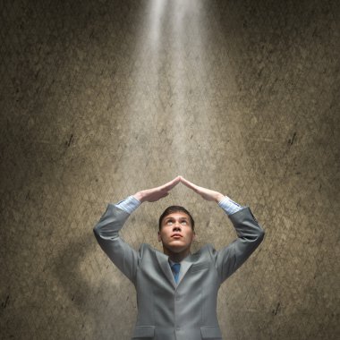 Businessman standing in rays of light clipart