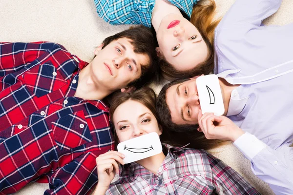 Four young men lie together — Stock Photo, Image