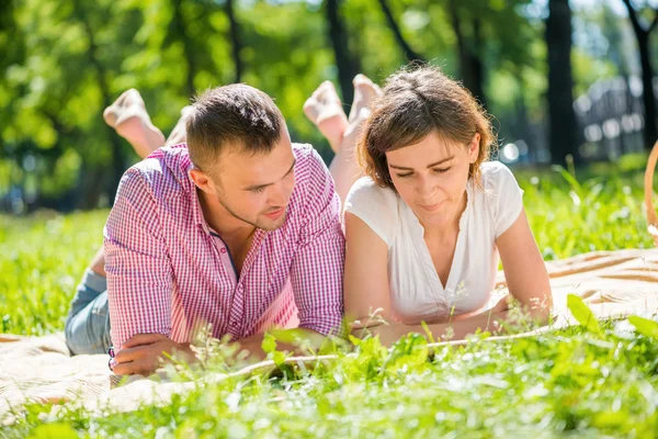 Romantic couple lying in park — Stock Photo, Image