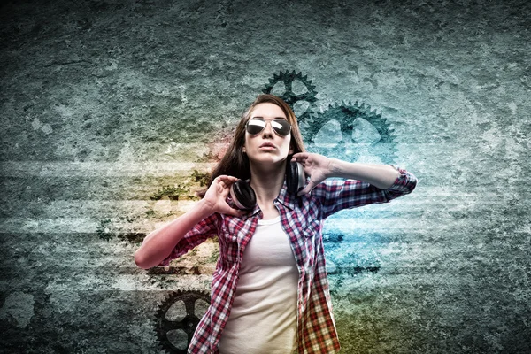 Teenager girl in shirt wearing headphones — Stock Photo, Image