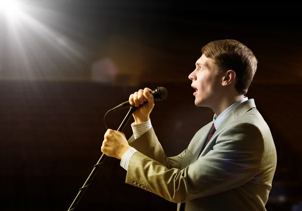 Businessman with microphone — Stock Photo, Image