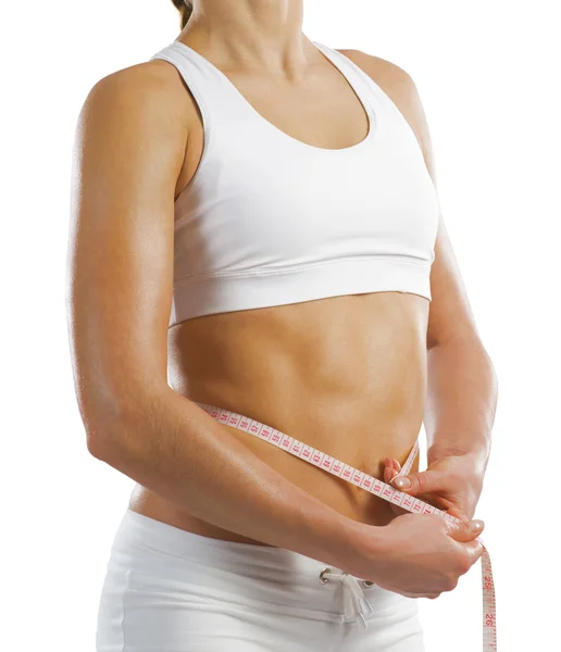 Athletic woman measuring waist — Stock Photo, Image