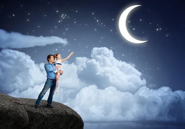 Father and daughter with moon on rope — Stock Photo, Image