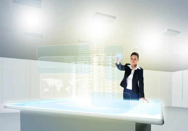 Businesswoman looking at hologram — Stock Photo, Image