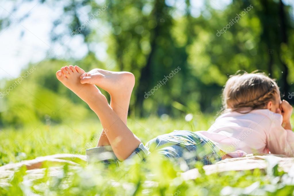 Girl lying in summer park