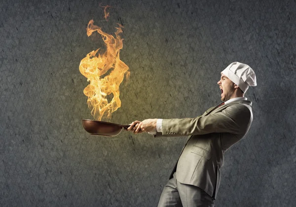 Businessman with pan — Stock Photo, Image