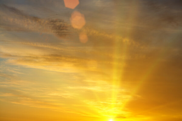 Peaceful warm image of yellow sunset and sunbeams