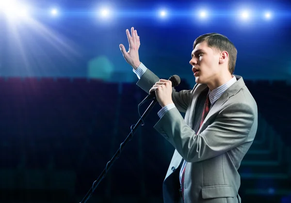 Businessman with microphone — Stock Photo, Image