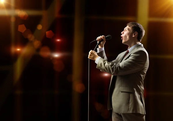 Businessman with microphone — Stock Photo, Image