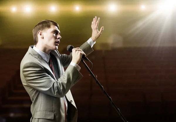 Businessman with microphone — Stock Photo, Image