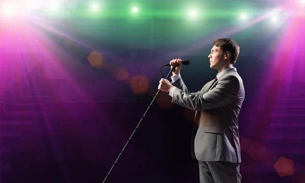 Businessman with microphone — Stock Photo, Image