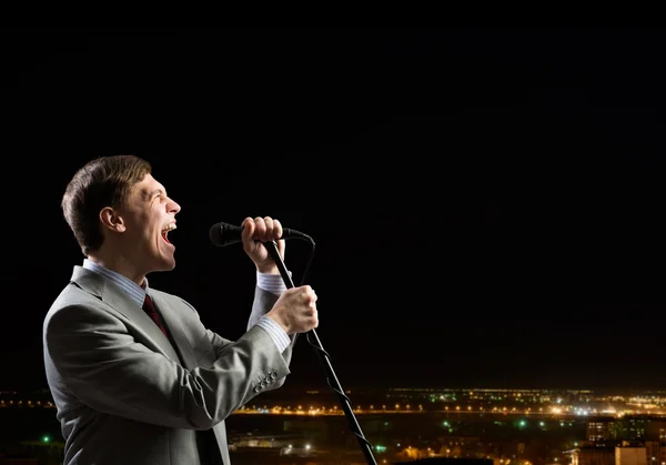 Businessman with microphone — Stock Photo, Image