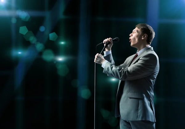 Businessman with microphone — Stock Photo, Image