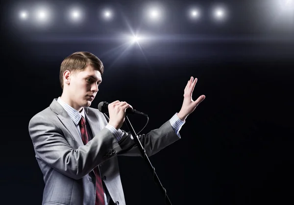 Businessman with microphone — Stock Photo, Image