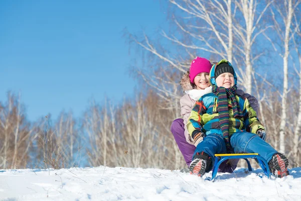 Two cute kids riding sled — Stock Photo, Image