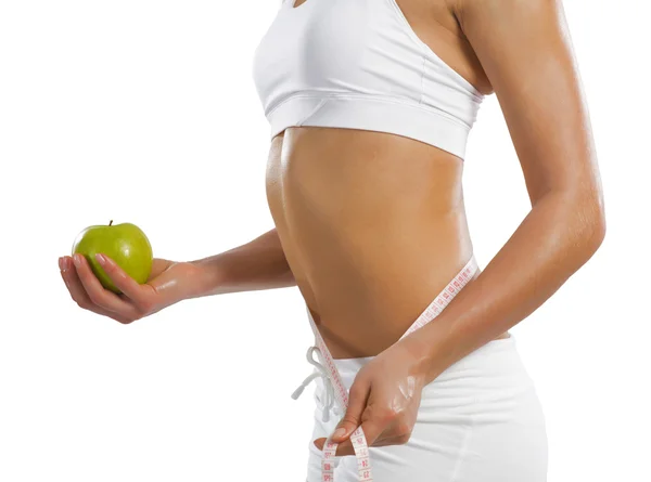 Young athletic woman holding a green apple — Stock Photo, Image