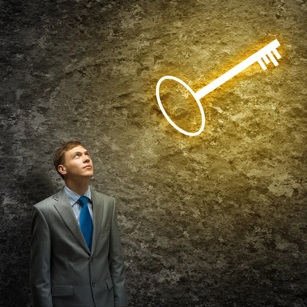 Businessman and key above head — Stock Photo, Image