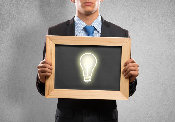 Businessman with frame light bulb — Stock Photo, Image