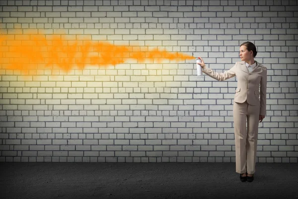 Businesswoman using spray — Stock Photo, Image