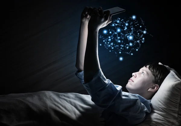 Teenager Reading in bed — Stock Photo, Image