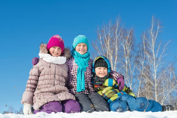 Three happy kids in winter park — Stock Photo, Image