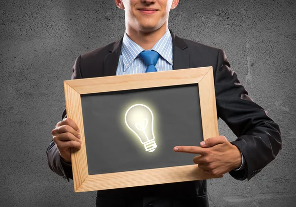 Empresário com lâmpada quadro — Fotografia de Stock