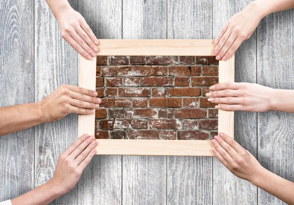 Hands holding frame — Stock Photo, Image