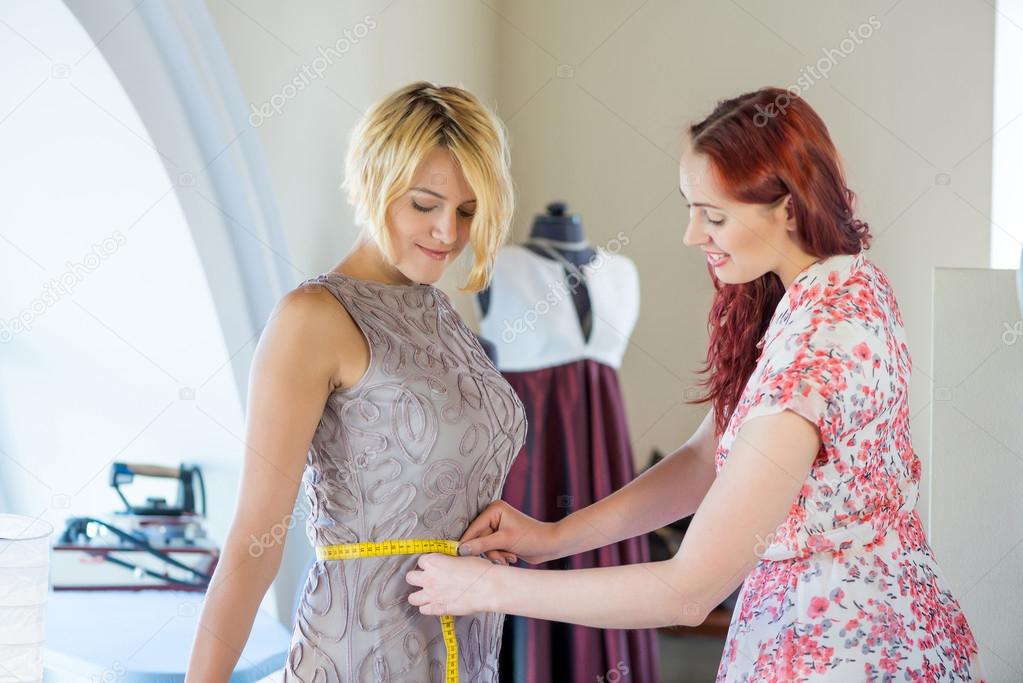 женщина примеряет платье.