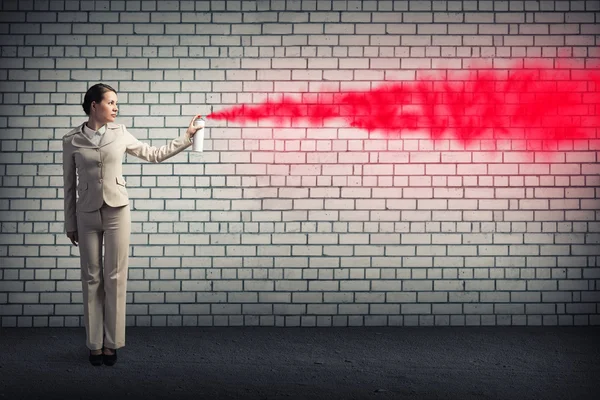 Businesswoman using spray — Stock Photo, Image