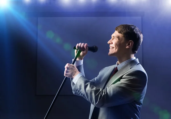 Businessman with microphone — Stock Photo, Image