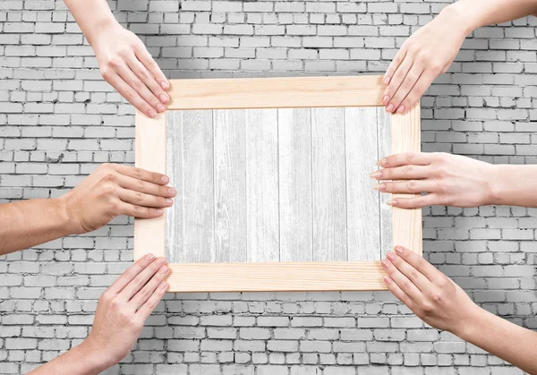 Hands holding frame — Stock Photo, Image