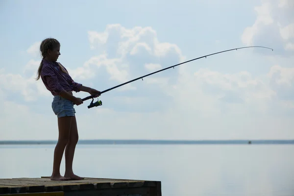 Girl fishing on pier — Stock Photo, Image