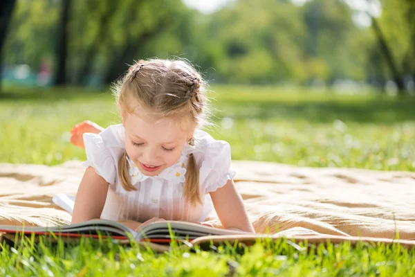 Dívka v parku, čtení knihy — Stock fotografie