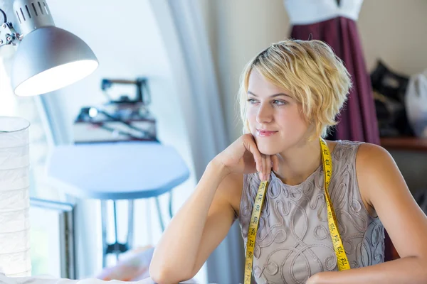 Needlewoman at studio with tape on neck — Stock Photo, Image