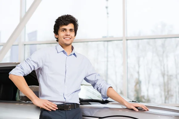 Joven hombre guapo en la sala de exposición — Foto de Stock