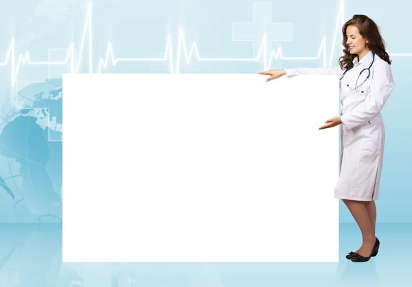 Young woman doctor near blank banner — Stock Photo, Image