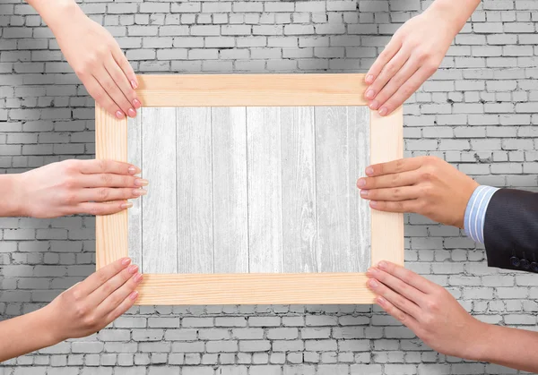 Hands holding frame