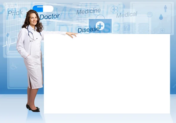 Young woman doctor standing near a blank banner — Stock Photo, Image