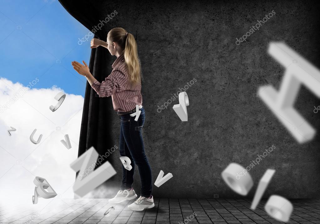 Woman pushes the curtain looking at clouds