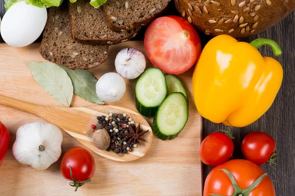 Vegetables and spices on kitchen table — Stock Photo, Image