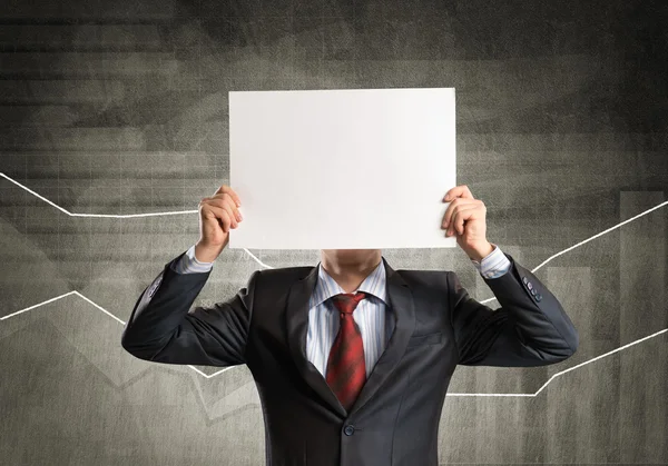 Businessman hiding his face behind paper — Stock Photo, Image