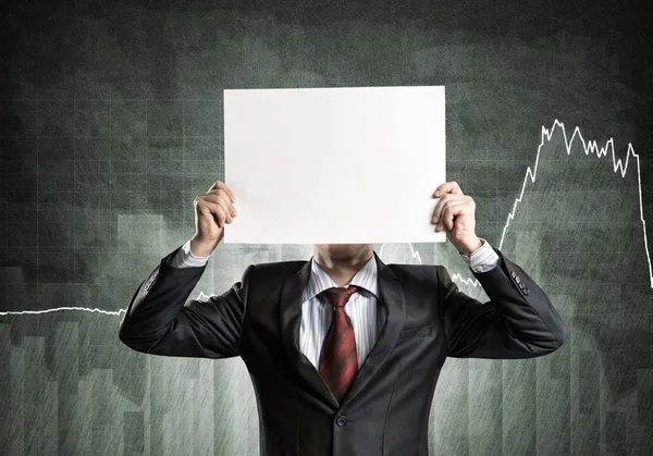 Businessman hiding his face behind paper — Stock Photo, Image