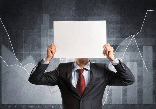 Empresario escondiendo su cara detrás del papel —  Fotos de Stock